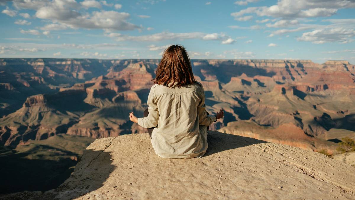 Woman meditating with headphones using subconscious shift aid for weight loss