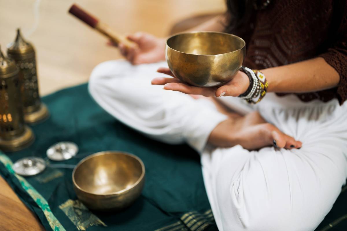 Woman practicing calm mind hypnosis for weight loss while seated comfortably with eyes closed